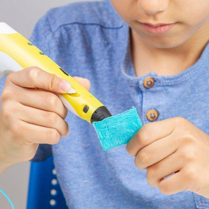 a small kid making things using the 3d pen printer