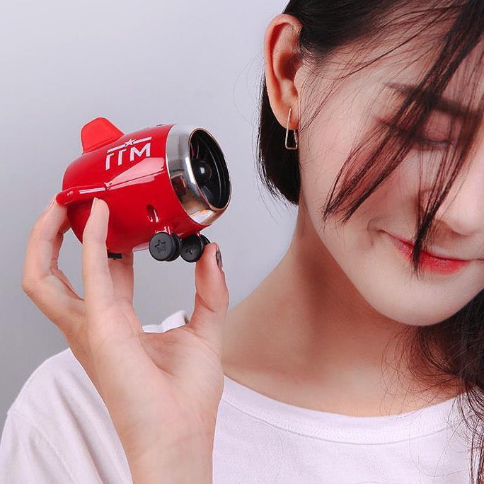 a girl holding the mini speaker 