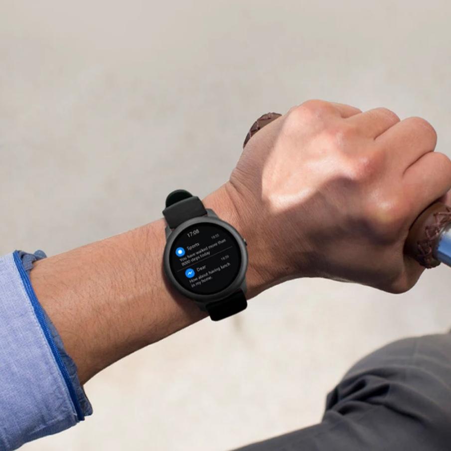 a man wearing the fitness watch while cycling 