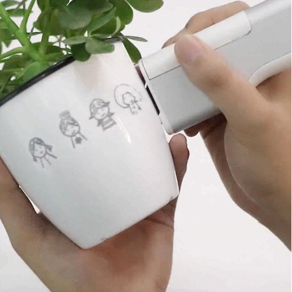 using handheld printer on a flower pot 