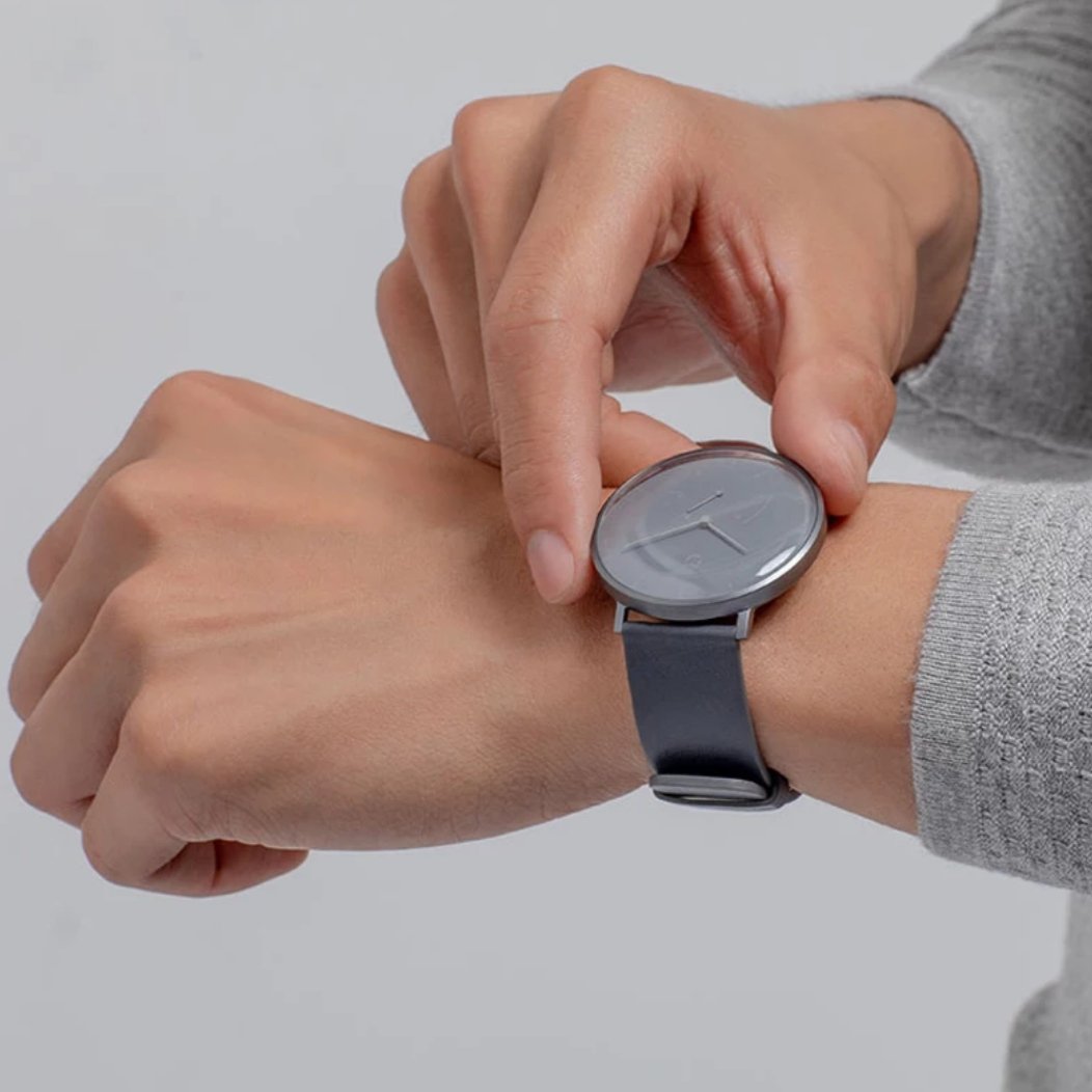 a man wearing the hybrid smartwatch 