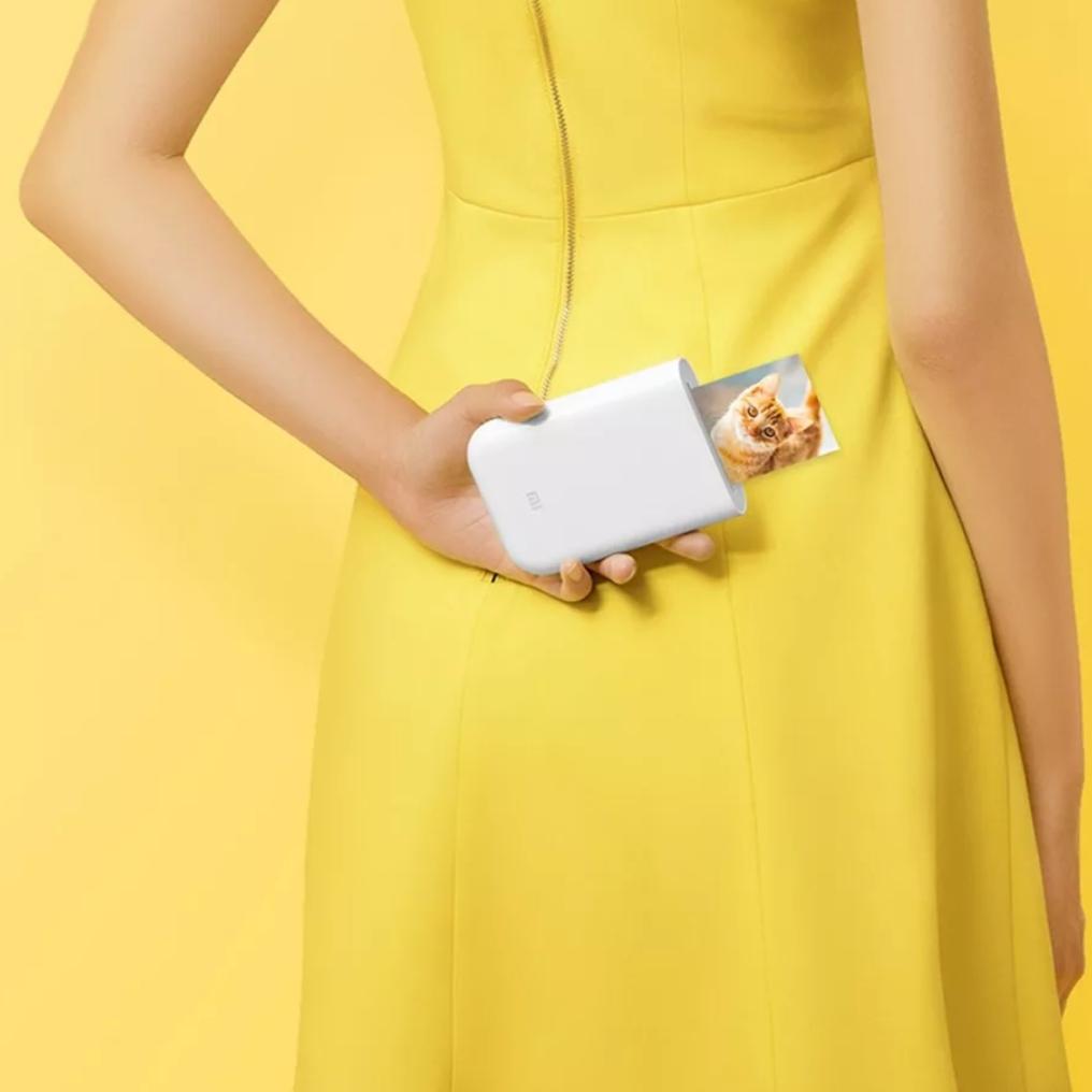 a girl holding the portable printer