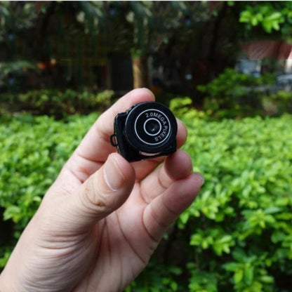 a person holding the mini spy camera 