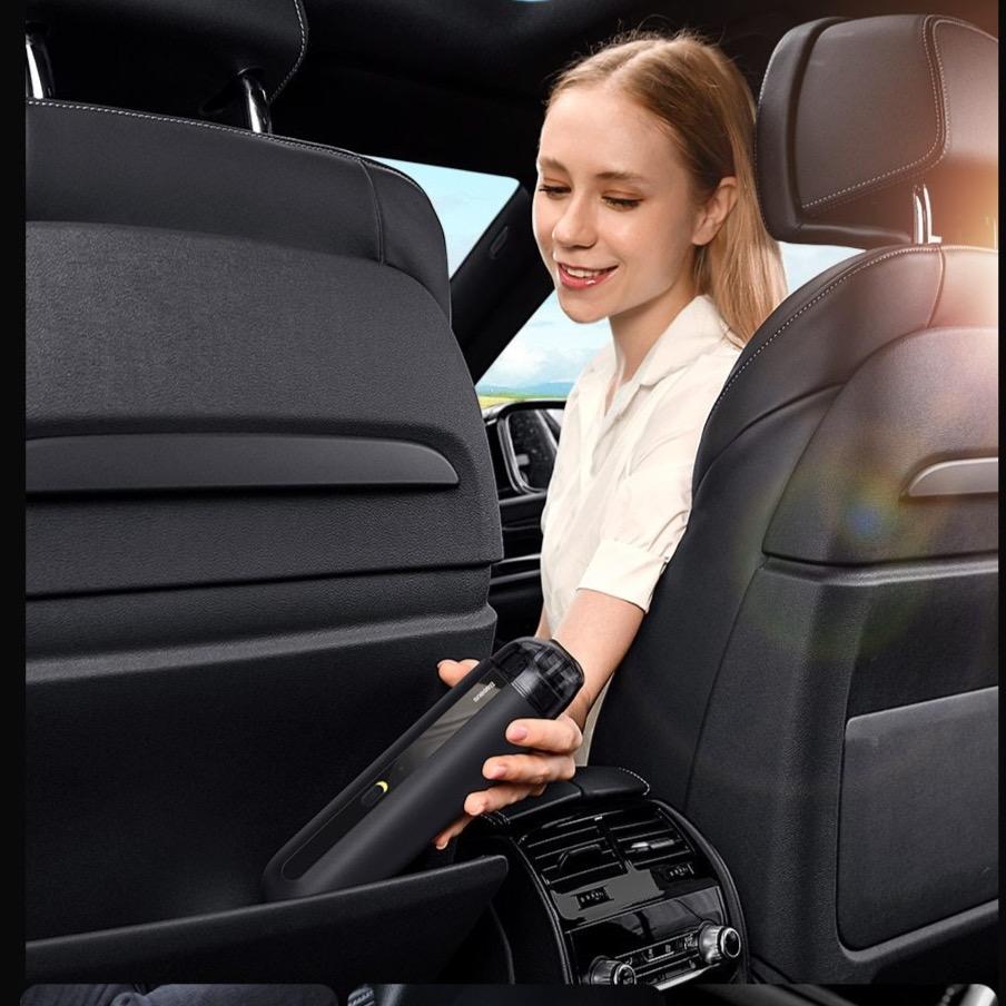 a girl using the vacuum cleaner for car 